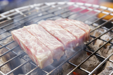 close up of raw beef sirloin grilling on stove