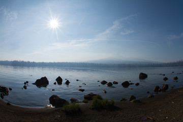 Naklejka premium Rocks on the shoreline of Big Lake in Oregon Deschutes National Forest on a sunny summer day..