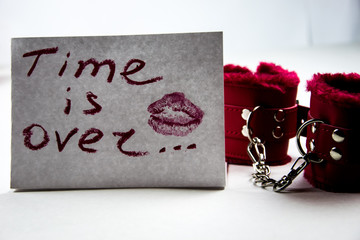 a note on white paper made with lipstick: time is over