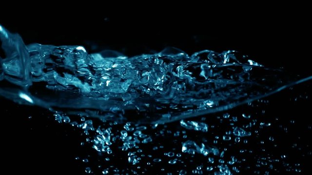 Boiling water in kettle on black background shooting with high speed camera slow motion