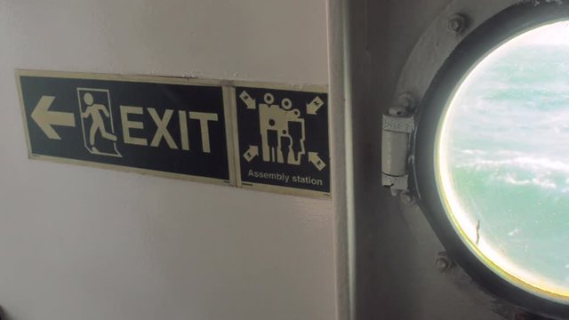Exit and Muster Station signs on a ship