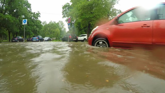 Cars move slowly in water