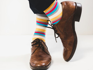 Men's feet in stylish shoes and funny socks