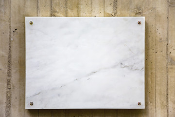 White marble board on a concrete wall