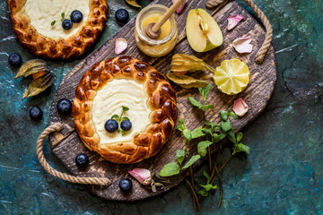 pie c fresh berries blueberries, fruit, with cottage cheese filling, cheesecake on a wooden Board