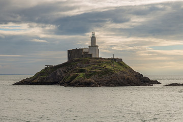 Fototapeta na wymiar A cloudy day at Mumbles Head Lighthouse in Swansea, Wales, UK