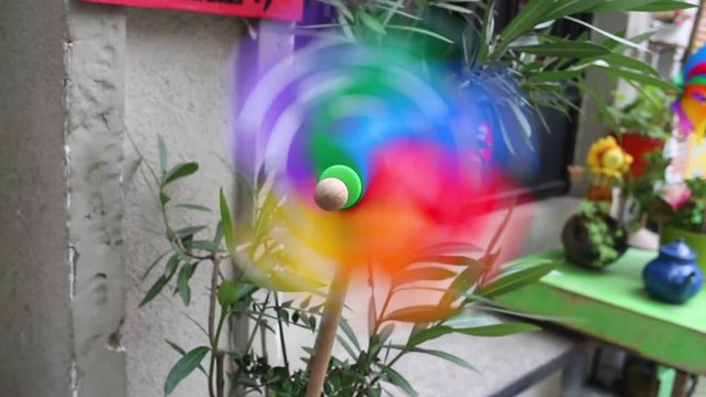 Close up of pinwheel with wind turbine, differential focus.