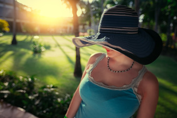 Beautiful young woman with sun hat enjoying her summer holiday in Punta Cana resort, Dominican Republic.