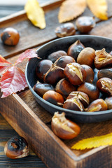 Roasted chestnuts in a cast iron skillet.