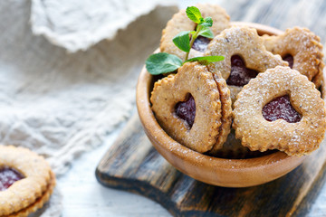 Cookies in the form of hearts in a wooden bowl.