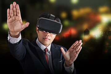 Portrait of businessman in a suit with virtual reality glasses on his head