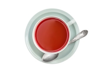 Cup of tea with tea spoon on white background. Top view.