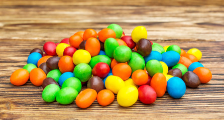 Heap of sweet round colorful candies on the table.