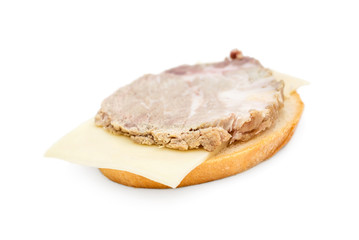 Sandwich with piece of smoked meat and cheese on white.