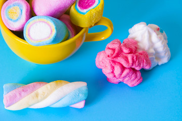 sweet. colored marshmallows on blue background