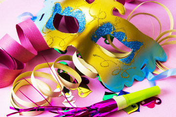 Carnival party background with confetti, serpentine, masks and party-busters
