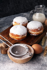 german donuts or berliner with ingredient on grey background
