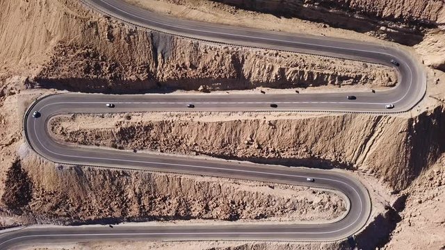 Desert road - Aerial footage of traffic going up and down a  serpentine mountain road