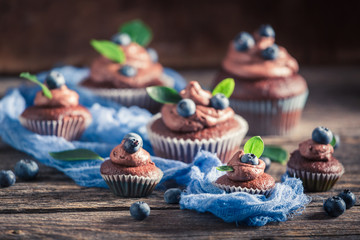 Homemade cupcake with fresh blueberries, cream and chocolate
