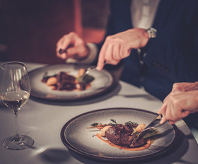 Couple eating stakes in a restaurant