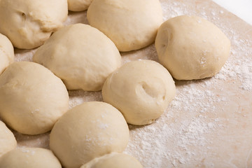 Fototapeta na wymiar Pieces of dough prepared for baking pies. Close-up view