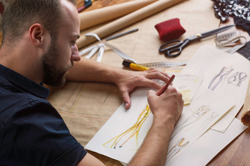 Couturier Makes Sketches of Dresses for Fashion Show