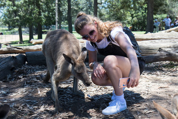 Young woman takes selfie with kangaroo - Powered by Adobe