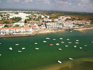 Fototapeta na wymiar Cabanas de Tavira en Portugal, localidad costera de Tavira en el distrito de Faro, región del Algarve.Fotografia aerea con Drone