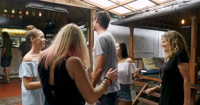 Single man dancing in the middle of 5 attractive ethnically diverse woman