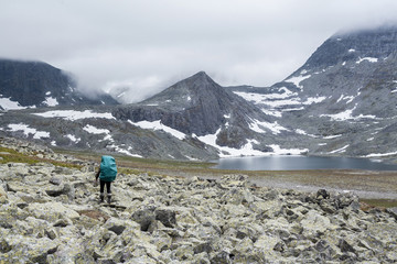 Fototapeta premium А severe hiker walking along the mountain path route. The Urals landscape. Russia landscape.