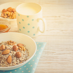 Healthy breakfast of muesli with nuts, honey and milk