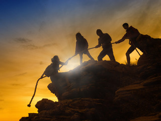 Silhouette of Asian climbers Helping friends in the team. Give up to the goal successfully.Help...