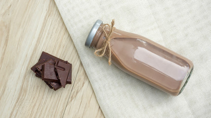 Fototapeta na wymiar Chocolate milk on a wooden table.