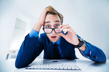 Businessman using computer, at office