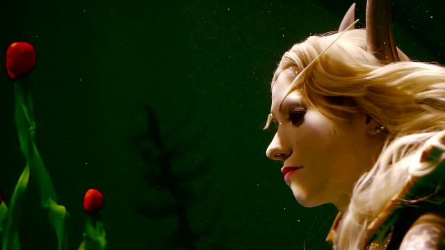 Close-up face of girl elf under water. dynamic backlight faces the glare of the sun.
