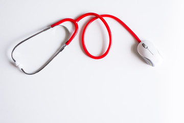 Stethoscope red color with mouse on desk,Medicine online concept,Top view with copy space