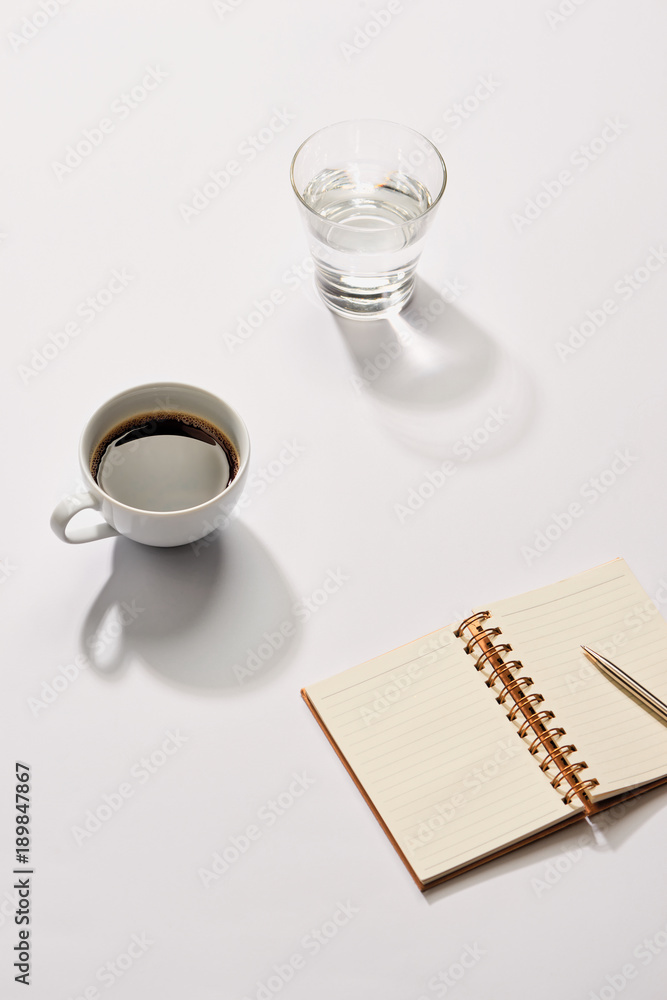 Aufkleber minimal styled flat lay table with open notebook, croissant and tea.
