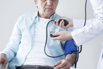 Elderly patient and nurse is measuring impulse 