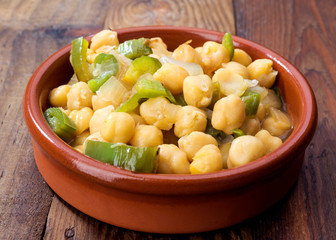 casserole of homemade stewed chickpeas on rustic board