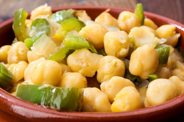 casserole of homemade stewed chickpeas on rustic board