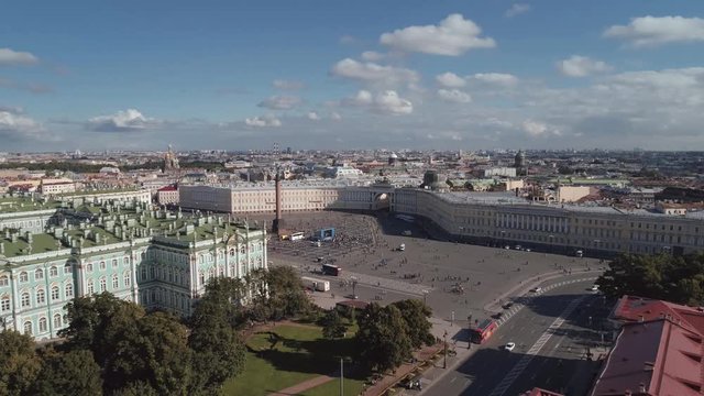 Aerial view of winter palace hermitage museum fasade. Alexander column with angel and cross. People walking, sunny day. Saint Petersburg, Russia