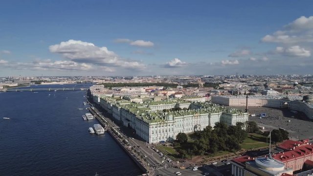 Aerial view of winter palace hermitage museum fasade. Alexander column with angel and cross. People walking, sunny day. Saint Petersburg, Russia