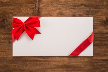 Envelope with red ribbon and bow 