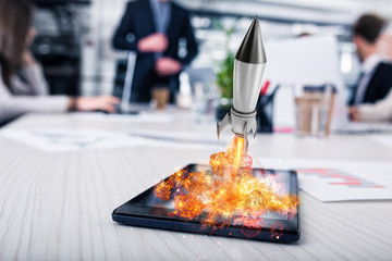 Rocket ready to starts from a tablet. concept of company startup