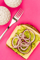 Vegetarian Avocado and Jarisberg Cheese Rye Bread Open Faced Sandwich With Sliced Onions