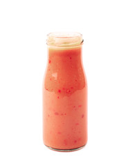 Red sauce in a glass bottle isolated