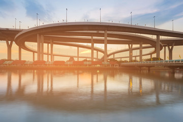 Fototapeta na wymiar Highway intersection river front with sunset sky background
