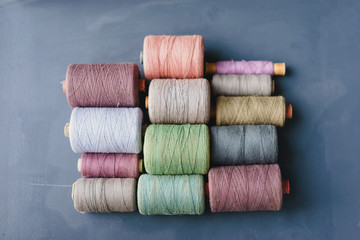 multicolored vintage thread spools on a blue background