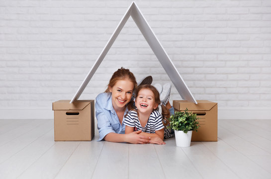 concept of housing, mortgage and relocation family mother and child with roof and boxes