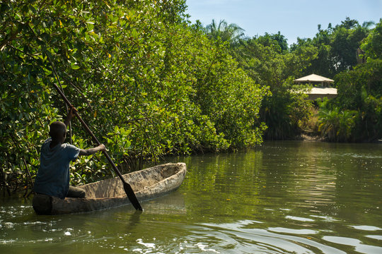 Children canoe in the river Gambia